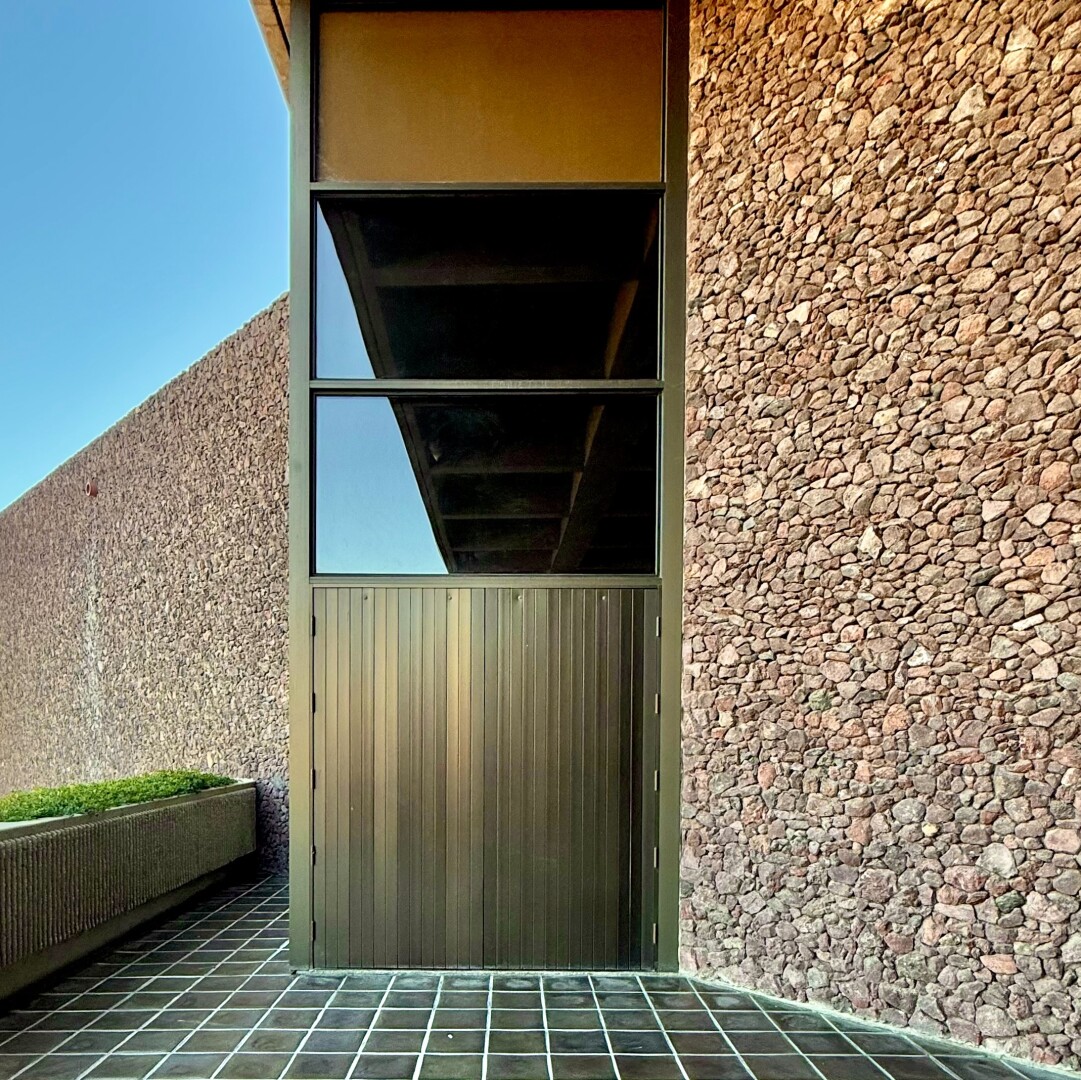 Reflection in a window where the angle aligns with the roofline, almost making it appear as if you're looking into the window instead of seeing a reflection.