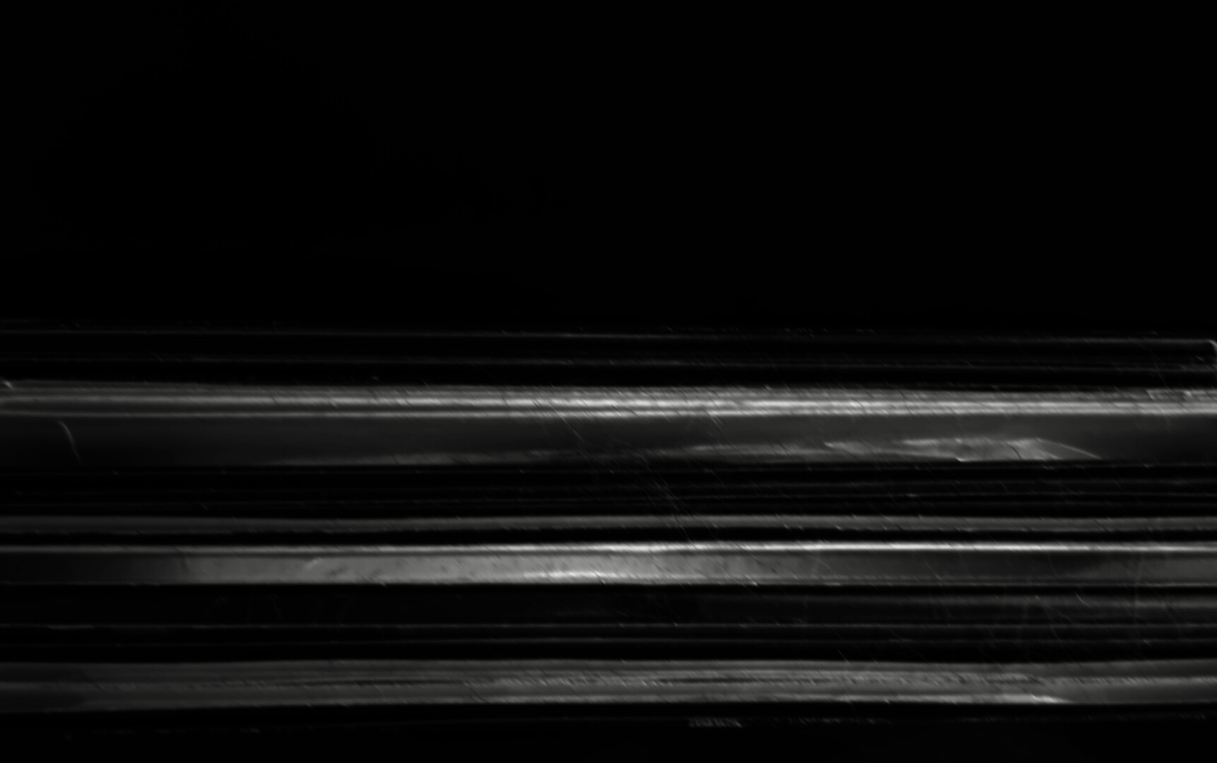 b&w, the edges of a few records leaning on a black speaker