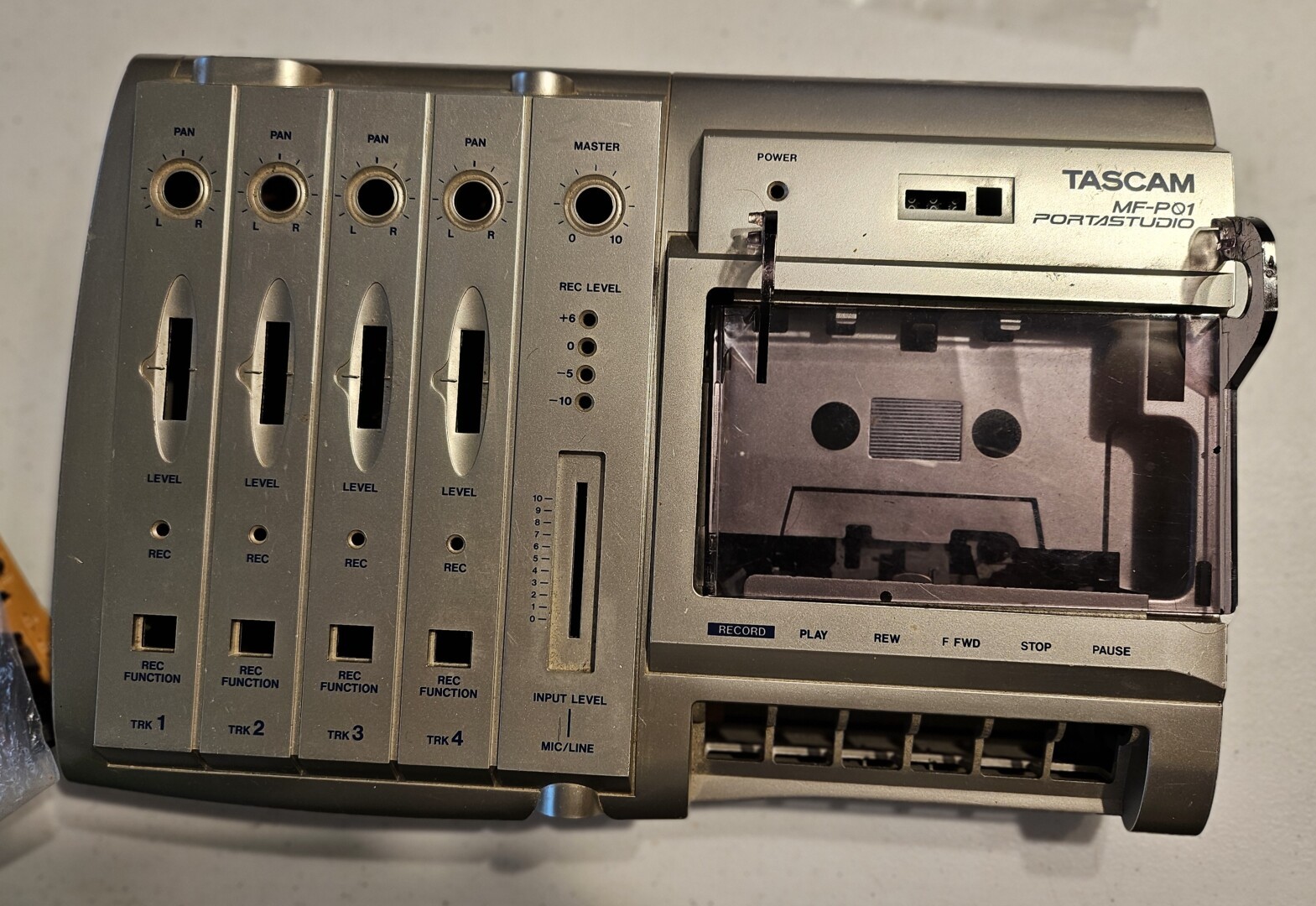 Closeup of the case to a disassembled TASCAM MF-P01. It is plastic, but looks metal. I find it especially aesthetic in dim light as the metallic finish really shines and seems more alive with the lightplay.