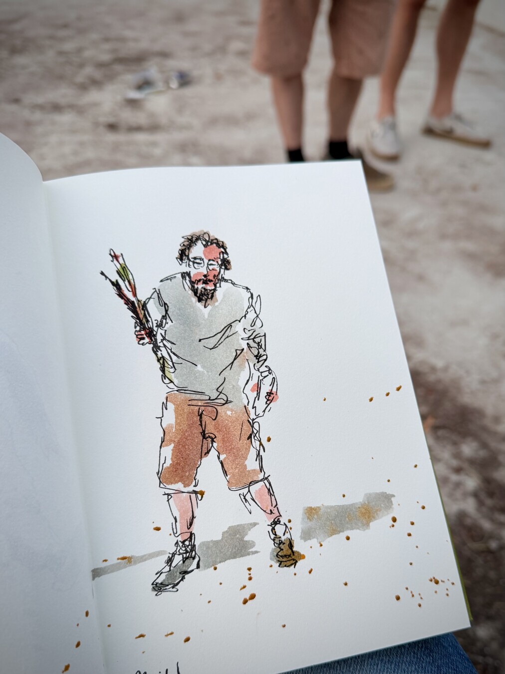 Pose of a man with beard and glasses walking hunched over two words viewer and with flowers in his right arm and holding a bottle in the left arm. Light grey shirt with short brown orange trousers.