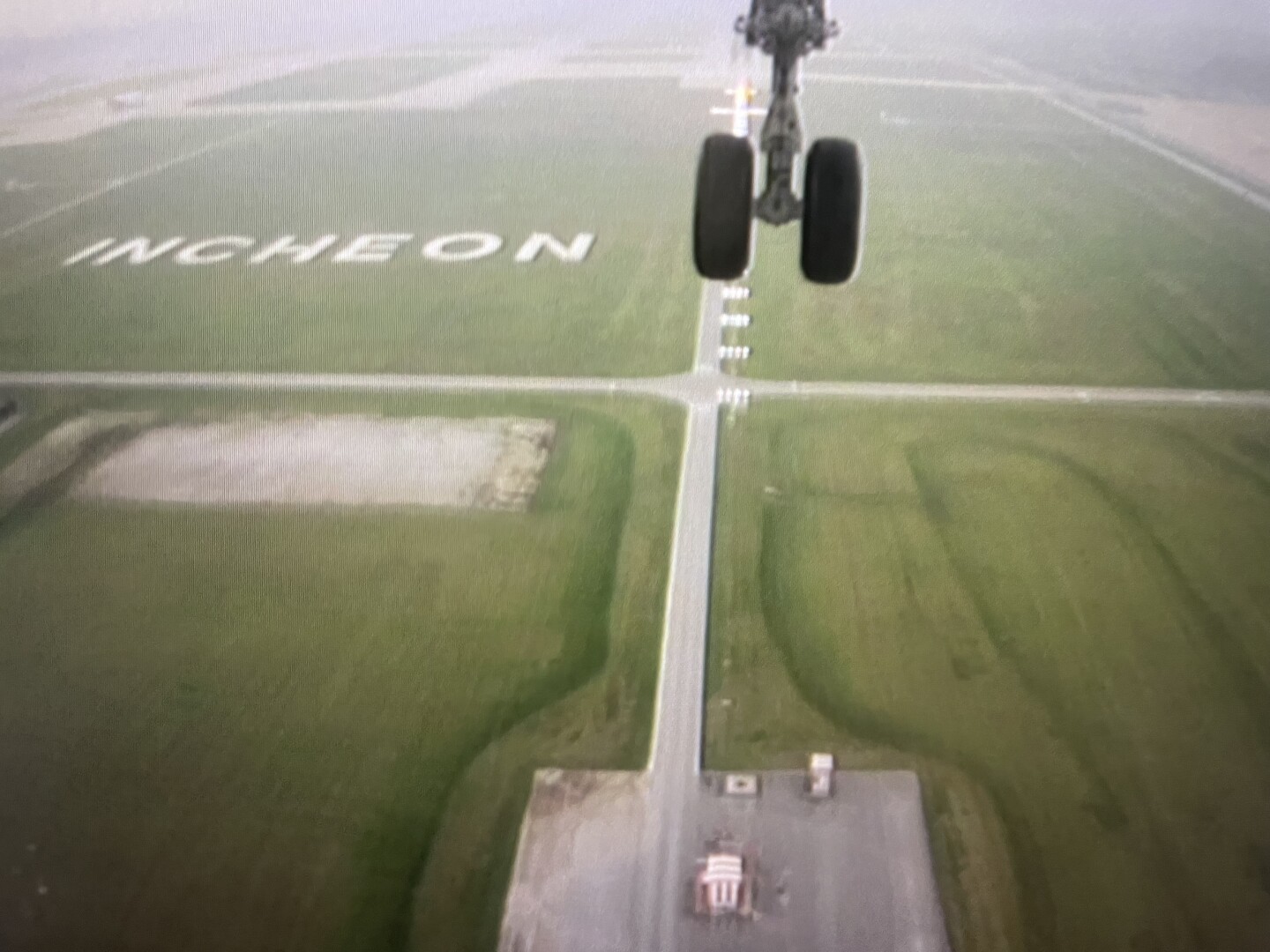 Bottom camera view of the plane landing at Incheon airport in Korea.