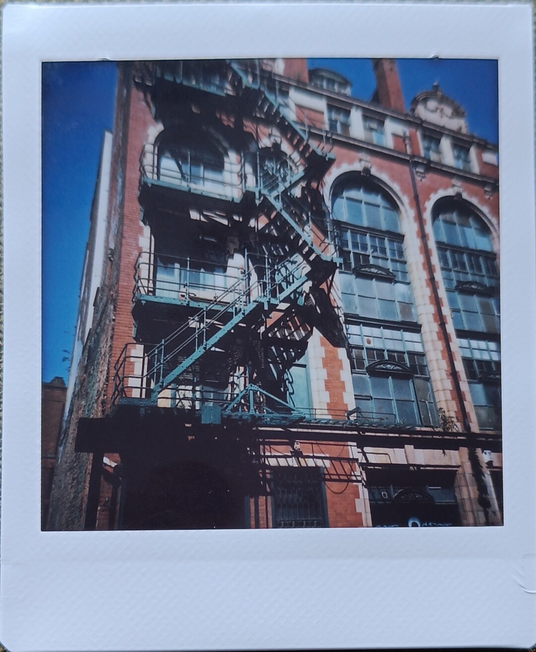 photo of old building with outdoor stairs for emergency exit, the framing could have been better
