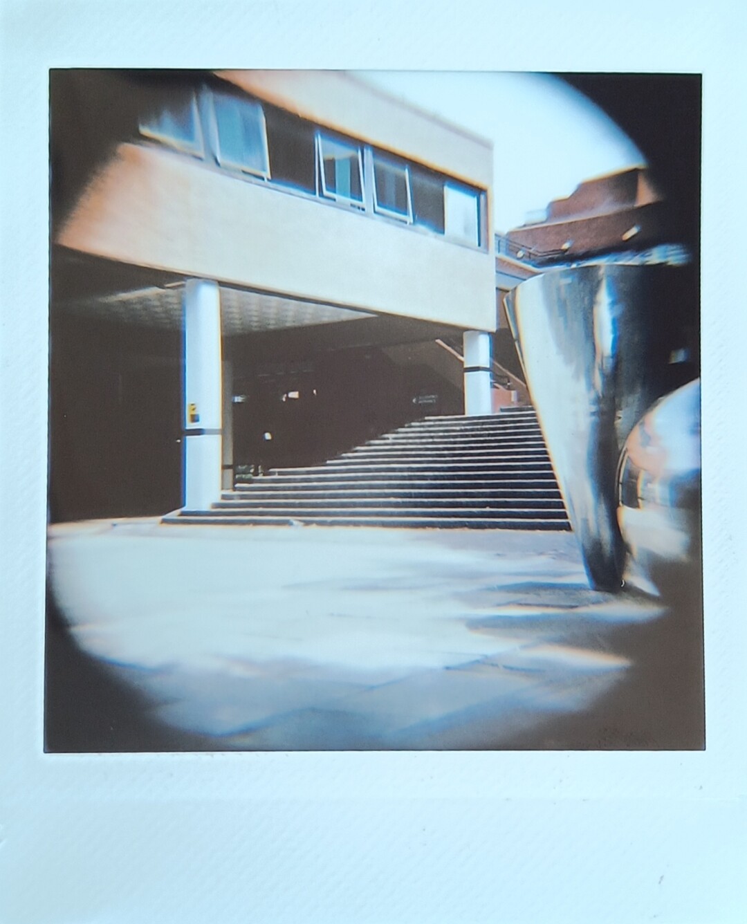 Stairs to a building with modern art on the right side