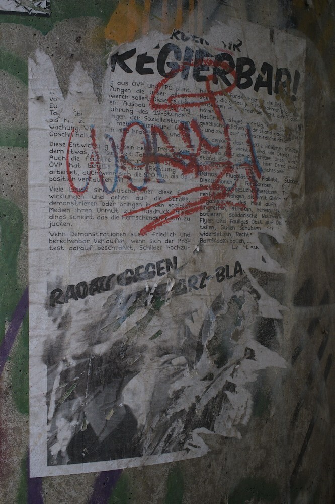 "We become ungeovernable" stands on a poster that was ripped apart.