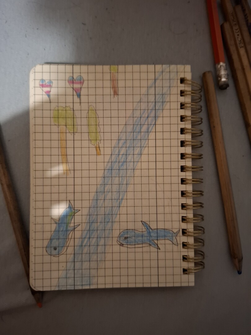 Drawing of a blåhaj family near river and trees near them plus 2 hearths with transgender colors
