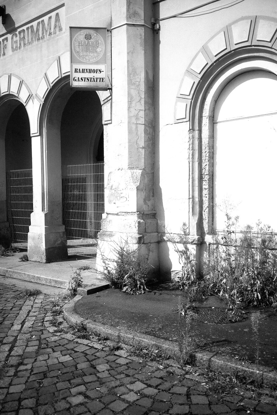 Front of the train station, everything is closed and abandoned. There is still a sign for the out-of-service station restaurant that has been there back in the days.