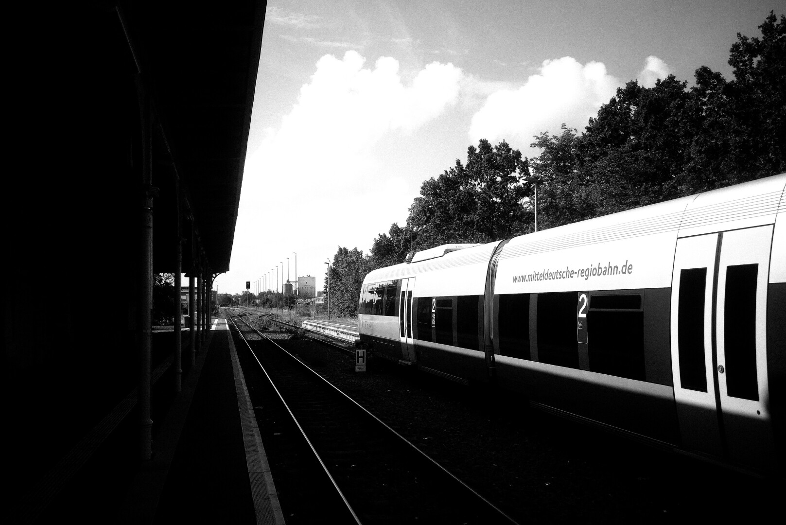 Train waiting on one track of the train stating.